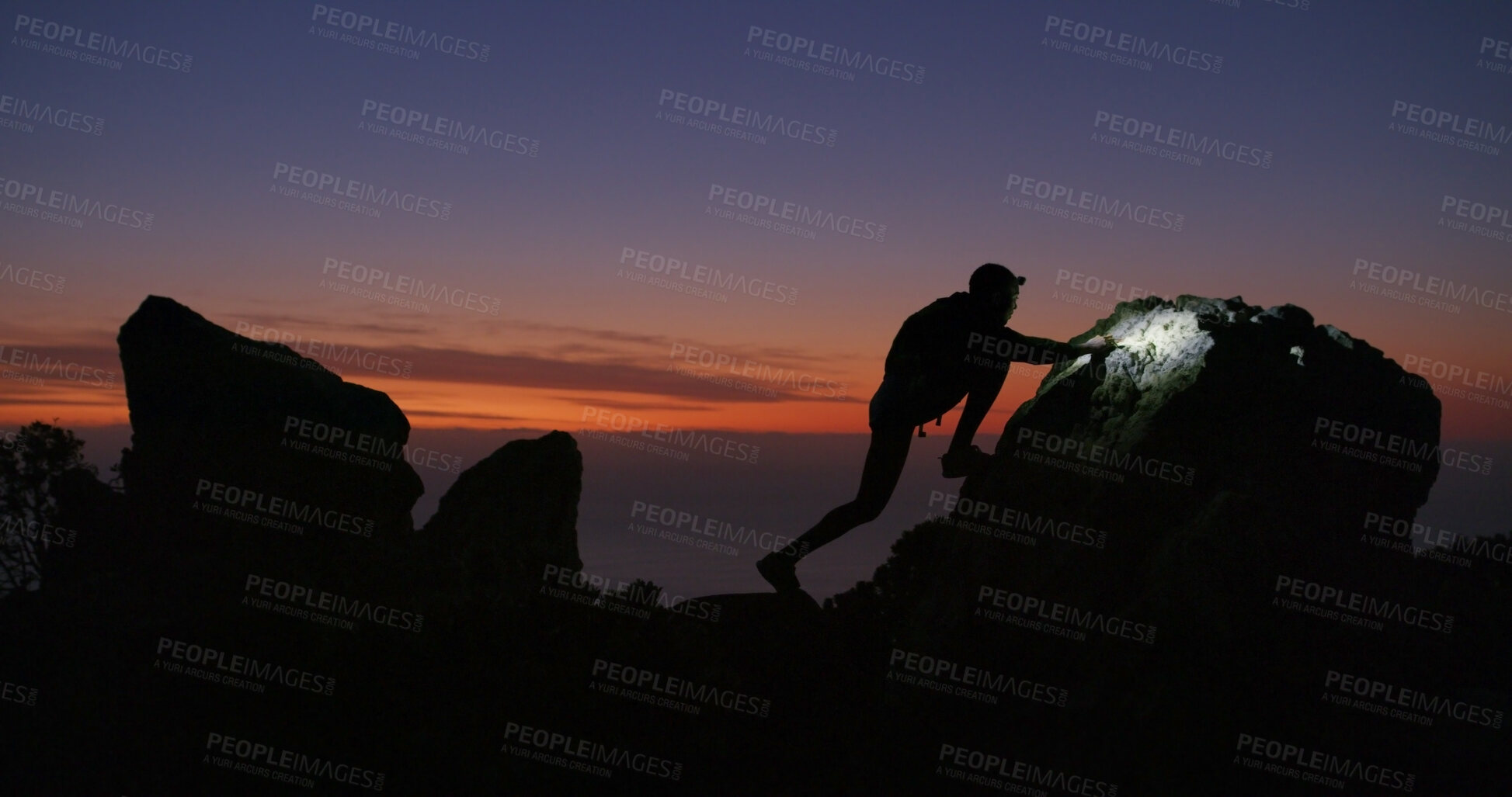 Buy stock photo Mountain climbing, night and silhouette with person outdoor in nature for adventure or journey. Boulder, hiking and sunset with adrenaline junkie in wilderness for fitness, hobby or wellness in dark