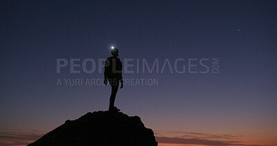 Buy stock photo Night, rock climber and fitness in nature, adventure or person on cliff with headlamp or silhouette. Outdoor, space and athlete on mountain for exploration, sunset and light for hiking in dark