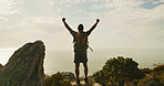 Man, celebration and hiking on mountain, sky and fist bump for success, clouds and ocean in summer. Person, trekking and goals on trail, summit or outdoor with back view for achievement in nature