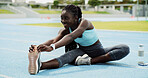 Runner, black woman and stretching legs on race track for health, wellness or exercise preparation. Sport, happy athlete and warm up muscle at stadium for practice, fitness and flexibility outdoor