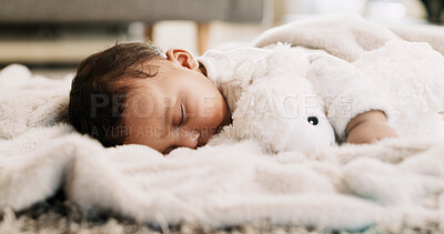 Buy stock photo Tired, baby and sleeping with teddy bear on floor for resting, nap routine or healthy development. Peaceful, infant and dreaming on blanket in home for child growth, wellness or comfortable on carpet
