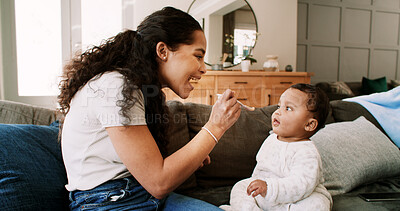 Buy stock photo Mom, baby and feeding with smile on sofa for nutrition, growth and wellness with bonding in home. People, mother and infant child with love, happy or eating food for diet on couch at family house