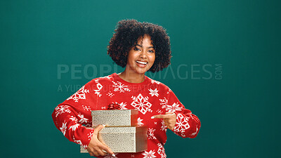 Buy stock photo Christmas, gift and portrait of woman in studio for holiday season, celebration or pointing. Festive event, xmas vacation and present with person on green background for space and December cheer