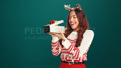 Buy stock photo Woman, Christmas and open gift box in studio, thinking and check with mockup space on background. Person, happy and excited with xmas present, package and festive celebration with jersey for holiday