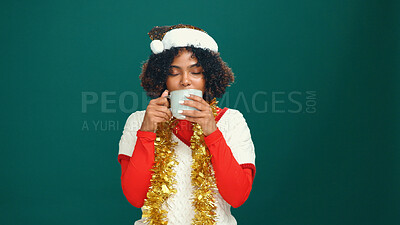 Buy stock photo Christmas, woman and drinking coffee in studio with winter eggnog for holiday on green background. Black person, xmas and tea with festive beverage, latte or enjoy espresso with mockup space