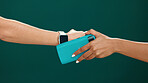 People, hands and watch with pos machine in studio for payment or purchase on a green background. Customer, person and wristwatch with NFC or scan for wireless transaction, tap or ecommerce on space
