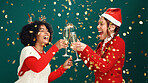 Happy women, christmas or celebration with champagne in studio for festive on a green background. Female people, excited friends or cheers with glass or gold confetti for new year or december holiday