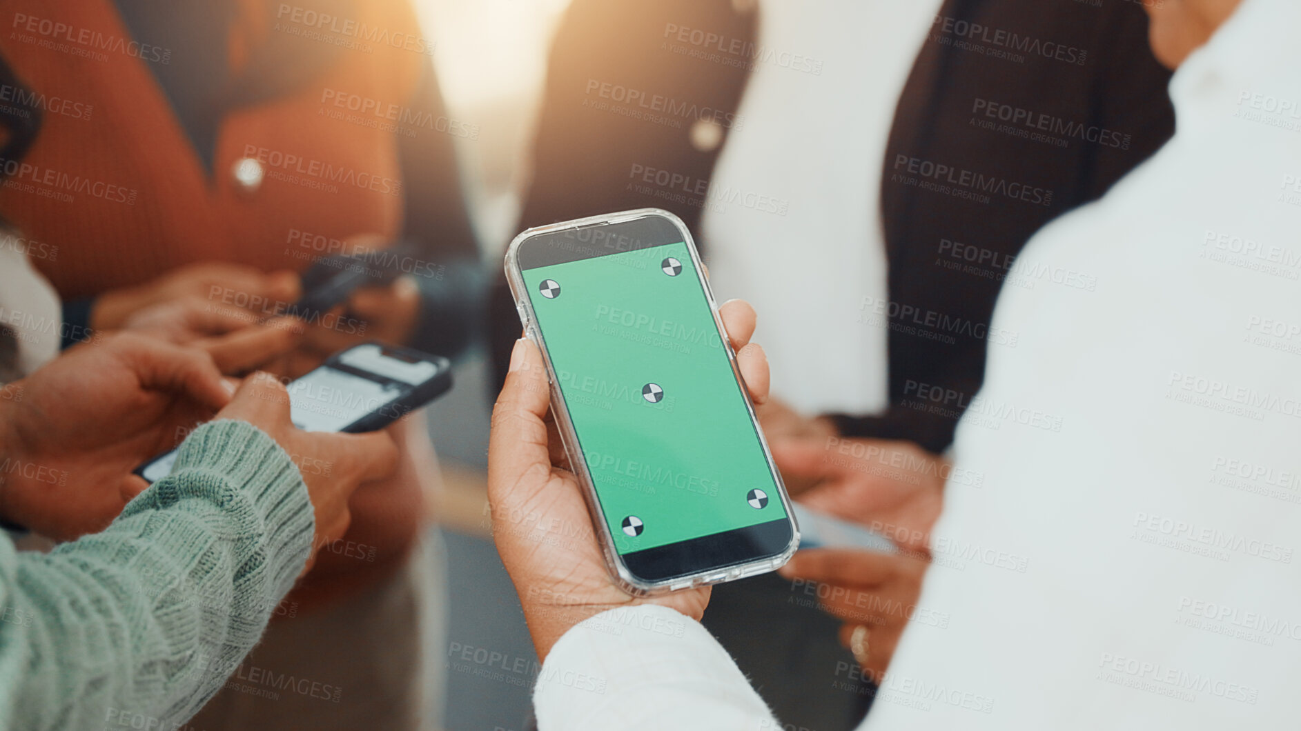 Buy stock photo Green screen, hands and phone with business people in circle at work for communication or networking. Huddle, information transfer and mobile with employee team in office together for connectivity