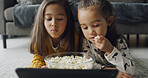 Child, siblings or watching with tablet in home for online entertainment or subscription. People, girl or sisters streaming with technology or popcorn for movie, snack or cartoon together on floor
