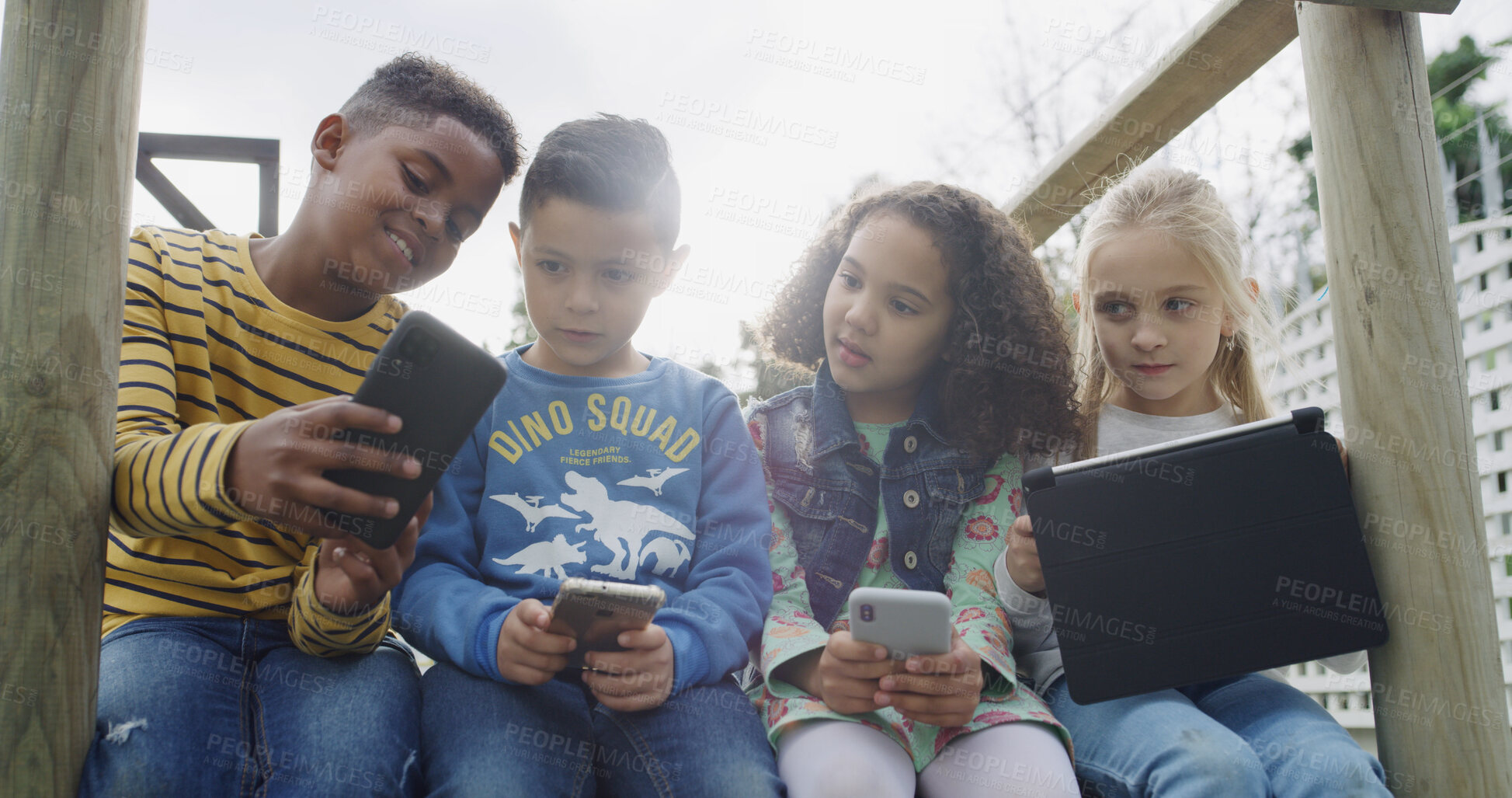 Buy stock photo Friends, kids and smile with technology in park for social media, fun and break in backyard. Children, together and bonding with phone, tablet and internet for holiday in playground for games or meme