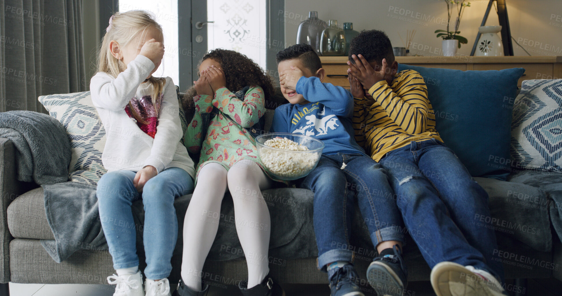 Buy stock photo Popcorn, scared and watching tv with children on sofa in living room of home together for bonding. Covering eyes, eating and television streaming with group of friends in apartment for horror movie