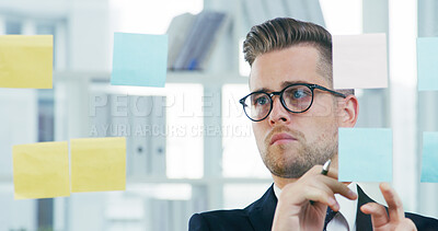 Buy stock photo Glass wall, planning and sticky notes with business man in office for brainstorming or solution. Development, storyboard and vision with employee in workplace for problem solving or strategy