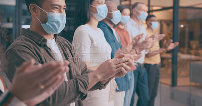 Buy stock photo Clapping hands, face mask and support with business people in office for achievement or success. Applause, crowd and motivation with employee group in PPE, celebrating bonus, goals or target