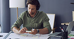 Architect, headphones or man with planning on blueprint for building layout, design ideas or strategy. Architecture, person or sticky notes with music at desk for construction guide or project review