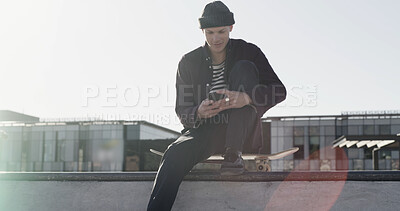 Buy stock photo Skater, man and typing with phone in city for text message, check skating schedule or social media. Skateboard, person or smartphone at skatepark for internet browsing, app download or practice break