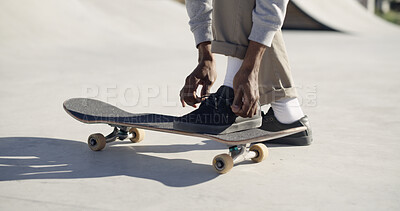 Buy stock photo Skateboard, hands and tie shoes outdoor to prepare for sports on half pipe. Legs, person and skater tying lace with sneakers to start exercise, fashion and ready for hobby in city with streetwear