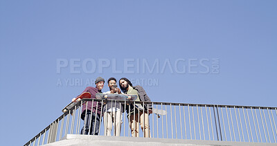 Buy stock photo Below, people and typing with skateboard, phone and mockup on blue sky space. Together, friends and gen z skater group with tech, smile and social media for fitness hobby and break for sport