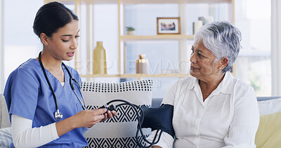 Buy stock photo Nurse, old woman and blood pressure test on couch for assessment, hypertension or advice at house. People, patient and medical consulting with monitor, check and exam for healthcare at nursing home