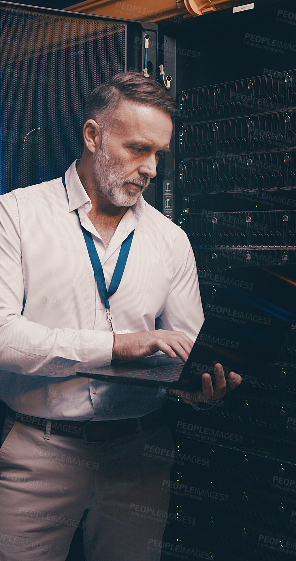 Buy stock photo Laptop, typing and technician or man in server room for cyber security, software update and database system. Programmer, developer and cybersecurity with mature person in data center as engineer