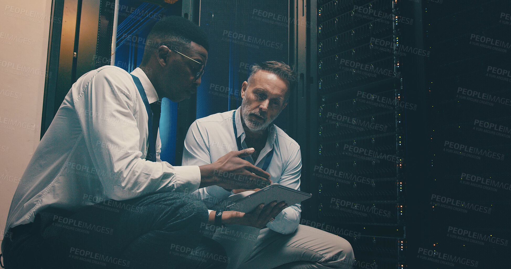 Buy stock photo Engineer, men and teamwork with tablet, server room and planning for software upgrade or discussion. Data center, people and review of information technology, IT specialist and network engineering