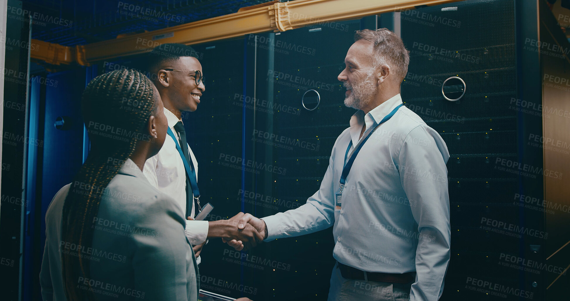 Buy stock photo Cybersecurity, handshake and meeting with people in server room for network administration deal. Agreement, thank you and welcome with team shaking hands in data center for tech support collaboration