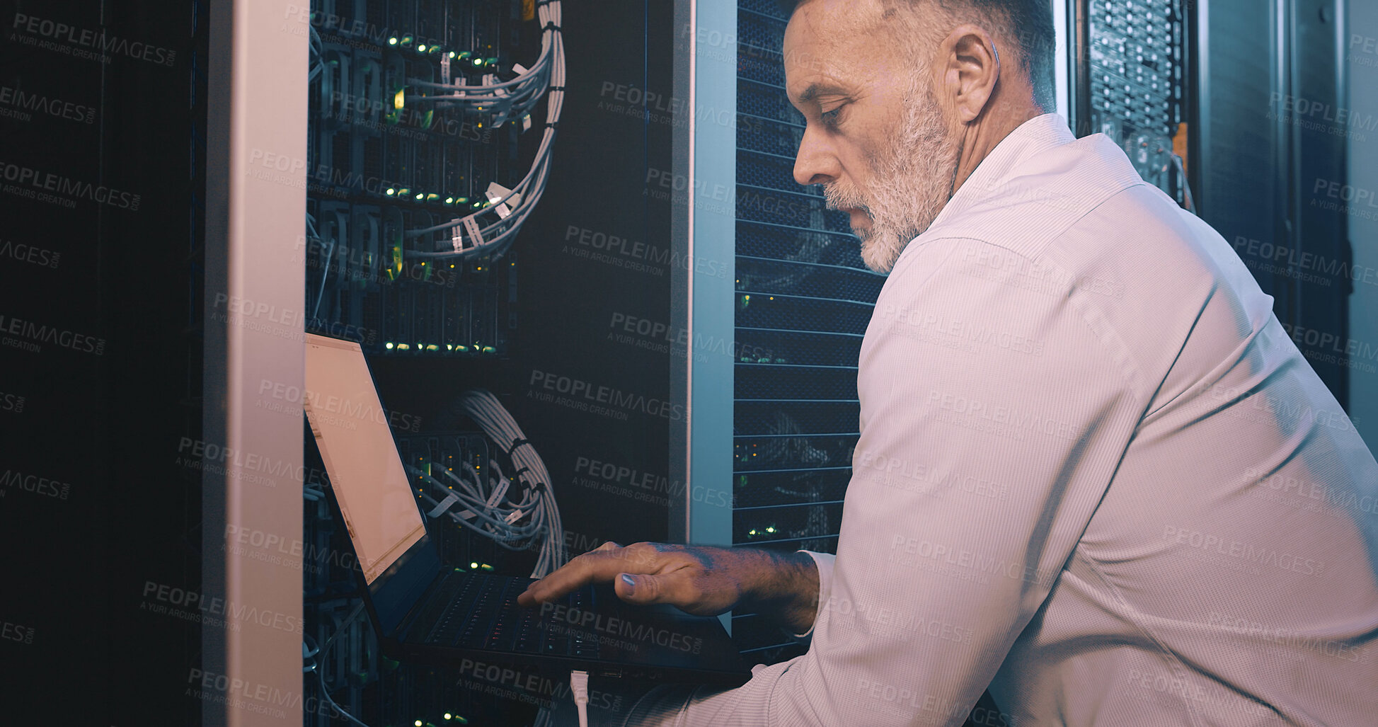 Buy stock photo Technician, man or typing on laptop in server room for diagnostics, system test or hardware repair. Engineer, mature person and tech in data center for network configuration, software update and GDPR