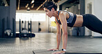 Push up, fitness and workout with woman in gym for exercises, core strength and health. Bodybuilder, challenge and abs training with person on floor of sports club for athlete, muscle and wellness