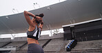 Stretching, athlete and woman at stadium, fitness and preparing for marathon, wellness and exercise. Outdoor, runner and back of person with workout routine, healthy and warm up on sports field