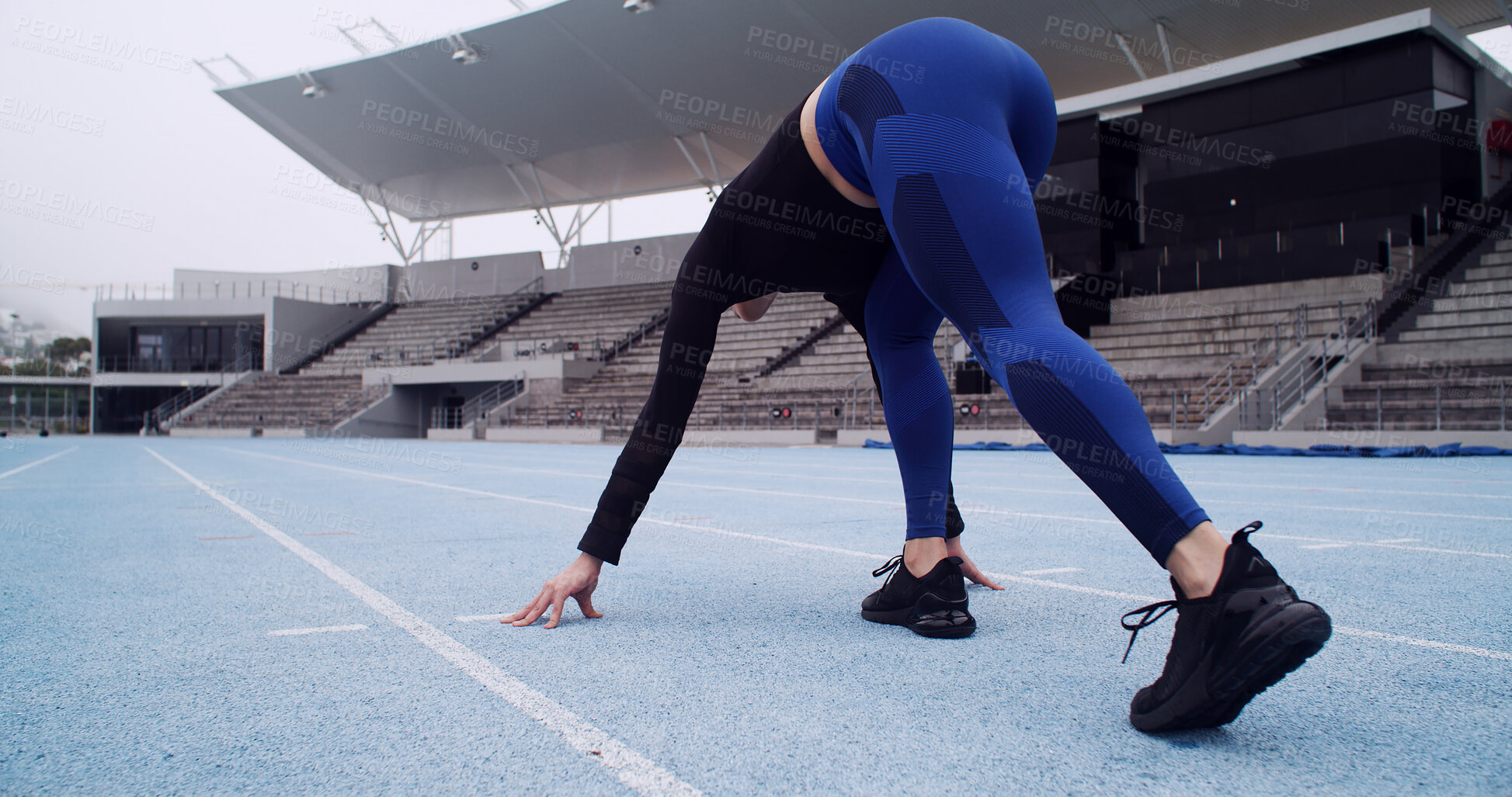 Buy stock photo Starting line, track and back of woman in stadium for running, practice or training for competition. Fitness, runner and athlete getting ready for race, cardio workout or exercise at sports arena.
