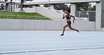 Athlete, runner and woman on track with speed for fitness, training and cardio performance. Sprinter, motion or fast female person with race running at stadium for sports, practice and exercise