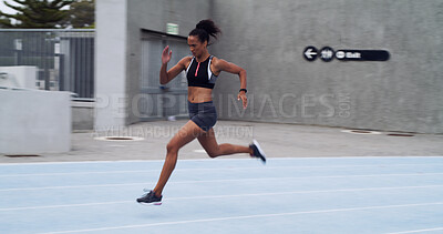 Buy stock photo Athlete, running and woman on track with speed for fitness, training and cardio performance. Sprinter, race or fast female person with runner at stadium for sports, practice and exercise workout