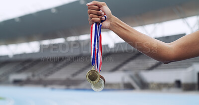 Buy stock photo Runner, winner and hands of athlete with medals at stadium for track champion, success and winning. Honor, person and awards outdoor for running achievement, sports performance and competition reward