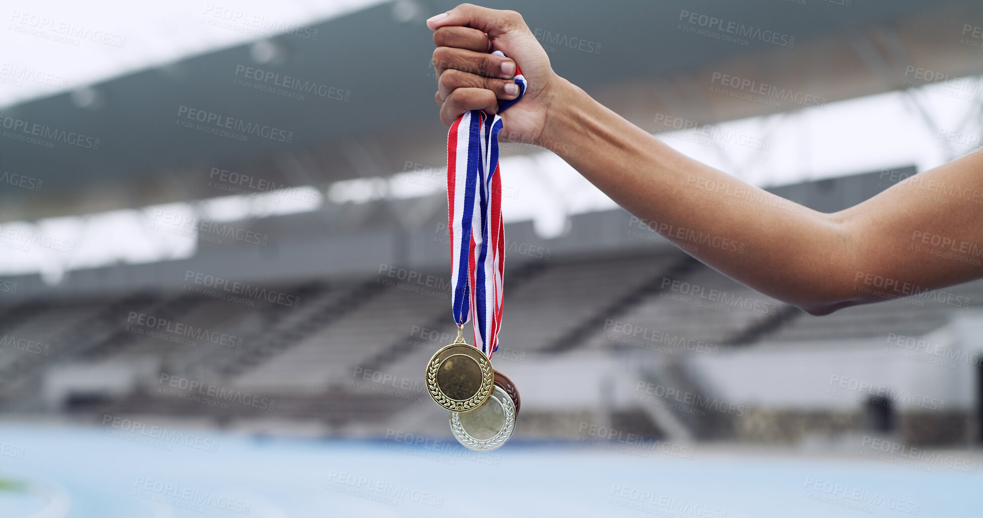 Buy stock photo Runner, winner and hands of athlete with medals at stadium for track champion, success and winning. Honor, person and awards outdoor for running achievement, sports performance and competition reward