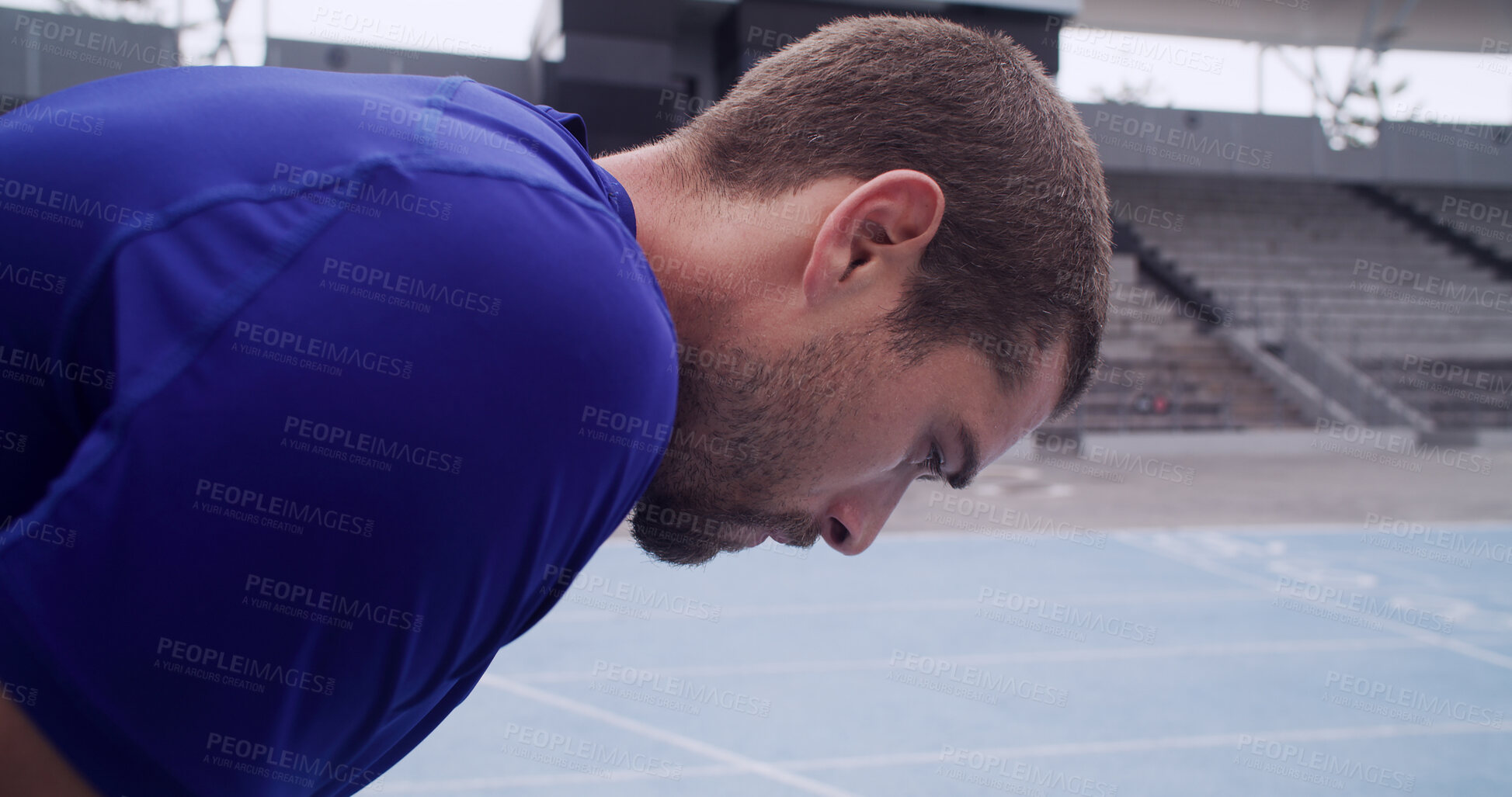 Buy stock photo Tired, runner and man on break at race track for exercise recovery, health and wellness outdoor. Stadium, exhausted athlete and rest for fitness, cardio challenge and fatigue for athletic sports