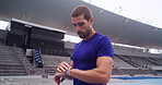 Man, athlete and smart watch at stadium with timer, stats and heart rate for performance training on track. Person, thinking and break with iot clock, stopwatch and fitness app for sport in Australia