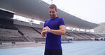 Man, athlete and smart watch at stadium with smile, stats and heart rate for exercise routine on track. Person, thinking and happy with results, stopwatch and fitness app for sports in Argentina