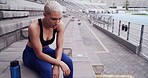 Runner, woman and tired with breathing at stadium for running recovery, overworked and resting. Athlete, girl and exhausted with break on stairs for training challenge, burnout and exercise fatigue