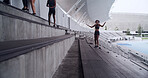 Runner, resting and team with people on stadium steps for workout break, fitness and support. Training drills, cardio challenge and sports athlete with friends on stairs for marathon practice