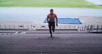Man, athlete and running with steps for fitness, performance training or practice at stadium. Active, male person or sprint with staircase, endurance or warm up for workout preparation for athletics