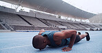 Man, athlete and push up on track, stadium and strong with balance, fitness or routine on ground. African person, exercise and training at sports club for muscle growth, workout or challenge in Kenya