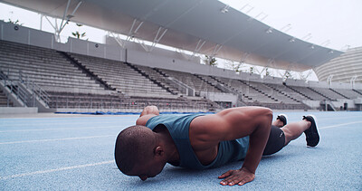 Buy stock photo Man, athlete and push up on track, stadium and strong with balance, fitness or routine on ground. African person, exercise and training at sports club for muscle growth, workout or challenge in Kenya