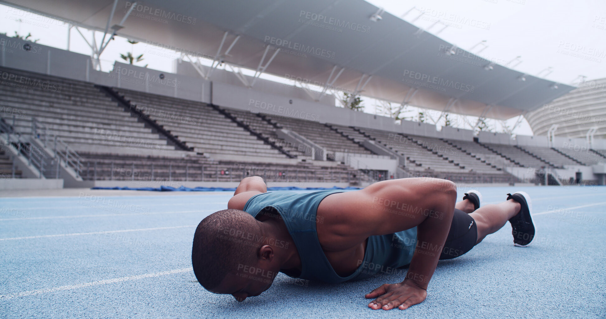 Buy stock photo Man, athlete and push up on track, stadium and strong with balance, fitness or routine on ground. African person, exercise and training at sports club for muscle growth, workout or challenge in Kenya