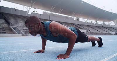 Buy stock photo Black man, athlete and push up on track, stadium and strong with fitness routine on ground. African person, exercise and training at sports club for muscle growth, workout and challenge in Nigeria