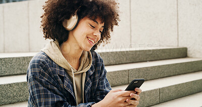 Buy stock photo Headphones, student and woman with phone in city for music, podcast and audio on college break. University campus, stairs and person on smartphone listening to radio, track and playlist in town