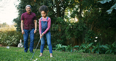 Buy stock photo Grandfather, girl and playing golf outdoor for hobby, learning skills and teaching technique. Family, old man and kid with sports in garden for bonding together, practice support or child development
