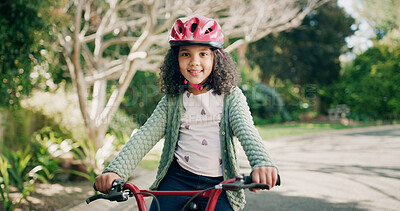 Buy stock photo Girl, child and happy with bicycle at park, portrait or outdoor with helmet, pride or confident in summer. Kid, bike and smile with safety gear for ride, fun and adventure with balance in Brazil