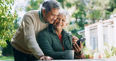 Buy stock photo Backyard, happy and mature couple with phone for funny conversation, bonding and relax outdoor Retirement home, coffee and senior man and woman on smartphone for internet, connection and website