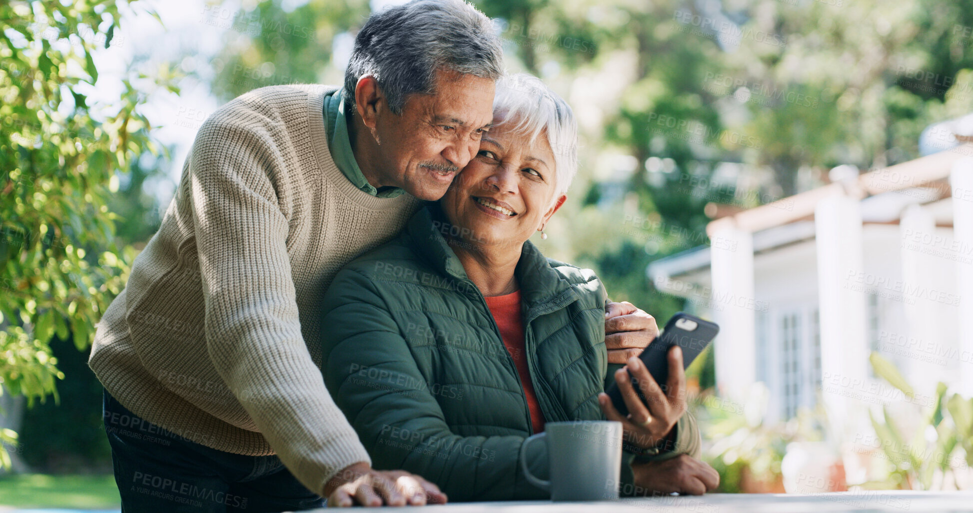Buy stock photo Backyard, happy and mature couple with phone for funny conversation, bonding and relax outdoor Retirement home, coffee and senior man and woman on smartphone for internet, connection and website
