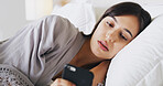 Serious, phone and woman relax in bedroom for text, message or reading post on social media. Morning, bed and girl in home for communication, check news and online chat with internet notification
