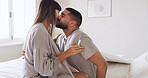 Pregnancy test, kiss and love with couple in bed for ovulation prediction, celebration and good news. Cycle tracking, fertility success and support with man and woman in home for positive result